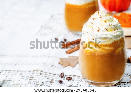 ice honey pumpkin spice latte with whipped cream. the toning. selective focus