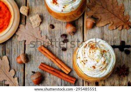 ice honey pumpkin spice latte with whipped cream. the toning. selective focus