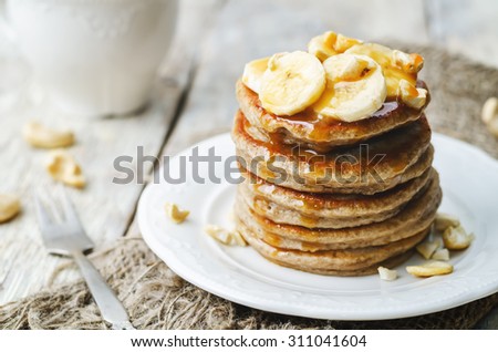 banana cashew pancakes with bananas and salted caramel sauce. the toning. selective focus