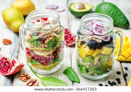 homemade healthy salads with vegetables, fruits, beans and quinoa in jar. toning. selective Focus