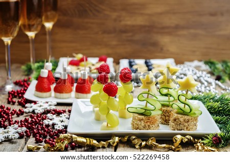 Assortment of New Year\'s snacks and a glass of champagne. toning. selective focus