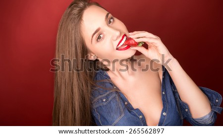 beautiful young girl eating strawberries
