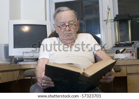 A senior Romanian Jewish man reads from his Jewish Prayer Book.  He was 91 years old at the time  of shoot.