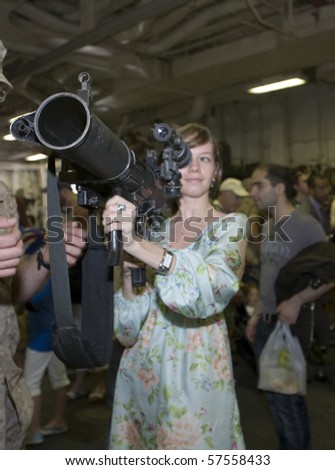 NEW YORK, NY - MAY 23: Civilian gets familiar with an M224 weapon.  Photographed during Fleet Week aboard the USS Iwo Jima May 23, 2009 in NYC.