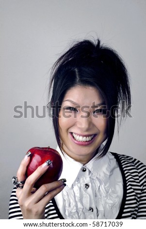 Asian woman holding apple.  She is Japanese and was in her early twenties at the time of shoot.