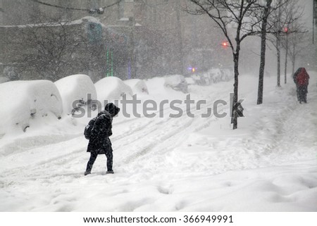 BRONX, NEW YORK - JANUARY 23: Woman crosses street during blizzard snow storm Jonas.  Taken January 23, 2016, in the Bronx,  New York.