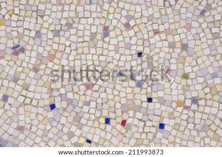 Mosaic of broken tile pieces on wall closeup