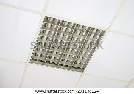 White suspended ceiling with fluorescent lamps closeup