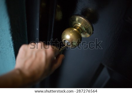 Woman opening a locked door