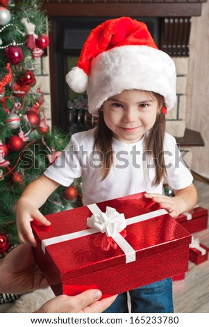 Christmas gift from father for little daughter in Santa hat