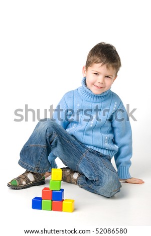 Boy builds a house out of blocks