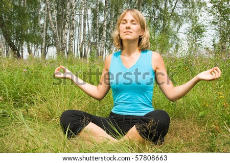 Beautiful woman meditates on the nature