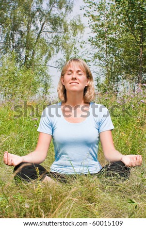 Beautiful woman meditates on the nature