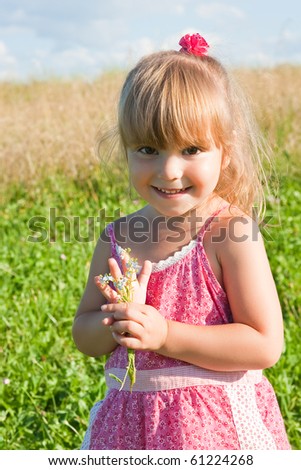 Funny girl in a pink dress with flowers