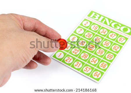 hand putting first chip to bingo game card isolated on white background