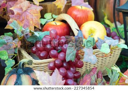Plastic fruit in basket for decorate contain apple, grape