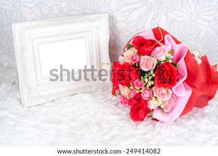 flowers bouquet placed with picture frame which have white space for your image