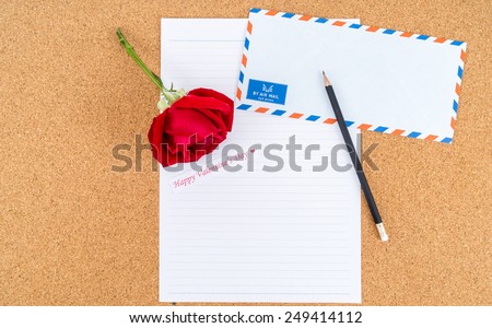 Cardboard, cork board with note paper with pencil and rose beside for writing love letter, space for text