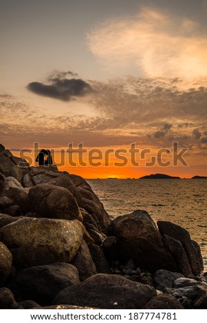 The couple with love and sunset at the beach in southern of Thailand sea