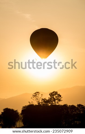 Hot air balloon fly up in the air with silhouette scene