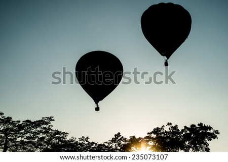 Twin hot air balloon fly up in the air with silhouette scene