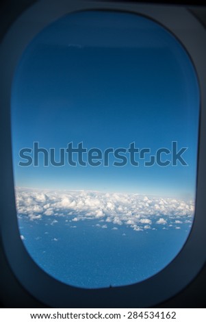 Blue sky outside the window of the air plane over Sydney, Australia.