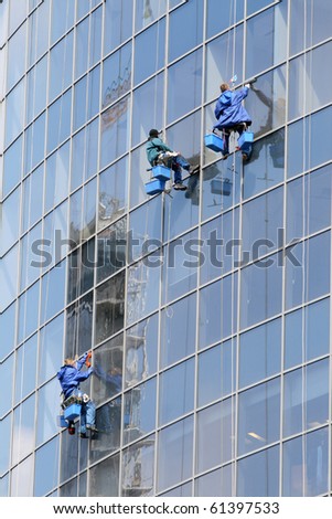 Three window washers on highrise office building