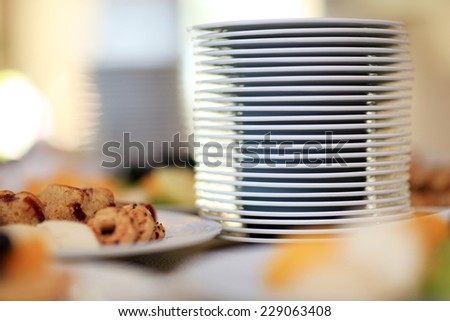Stack of plates on table. Breakfast food. Shallow DOF