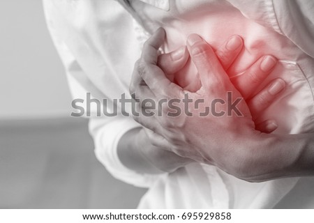Man clutching his chest, acute pain possible heart attack.Heart attack symptom-Healthcare and medical concept.