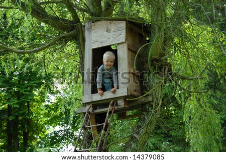 Young boy in a hut in a tree
