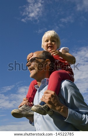 Young happy girl sitting on shoulder