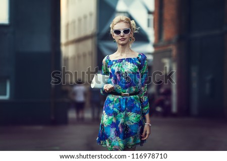 Beautiful stylish young woman on a street