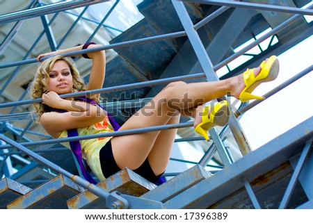 A blond woman on stairs