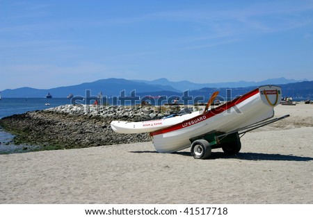 Lifeboat on a dolly on sandy English Bay Beach on West Coast
