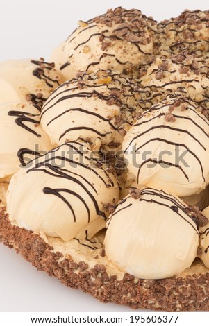 part meringue cake with chocolate and ground nuts on a white background