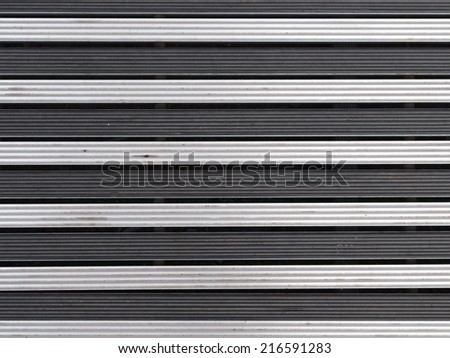 texture of silver metal and black horizontal stripes