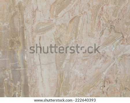 large slab of variegated striped beige marble with smooth smooth polished surface