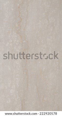 large slab of solid smooth beige marble with orange streaks and light and dark spots