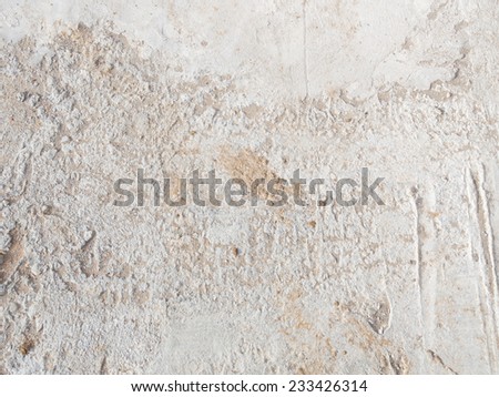 gray concrete floor with small pits and stripes and vnih hammered yellow sand
