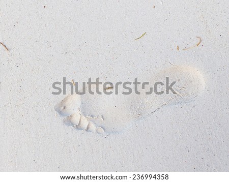 human footprint on the feet on the clean white sand