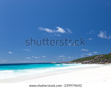 Best beach Anse Lazio with white fine clean sand on the island of Praslin Seychelles and large granite stones with a tropical green forest