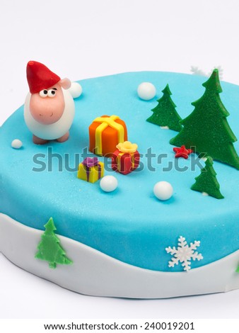 Creative fabulous cake decorated with cheerful sheep trees presents snow snowflake