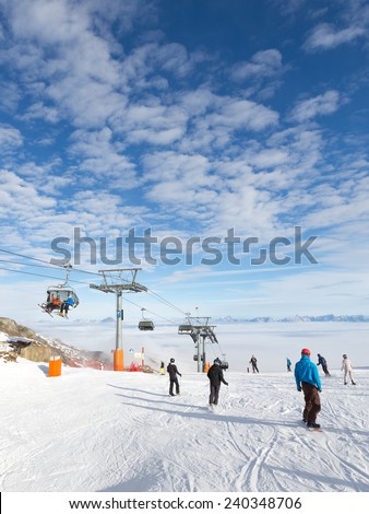 Zell am See - Kaprun - December 6, 2014: People skiing and snowboarding in the winter above the clouds at the ski resort of glacier Kitssteynhorn - December 6, 2014, Zell am Cee - Kaprun, Austria