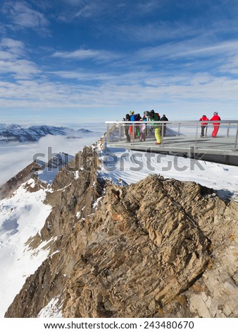 Zell am Cee - December 6, 2014: People on the observation deck admiring the mountain winter landscape in snowy Alps of 6 December 2014, Zell am Cee, Kaprun, Austria