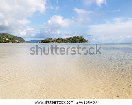 small beautiful tropical island with palm trees and clean salt water Indian Ocean, Seychelles