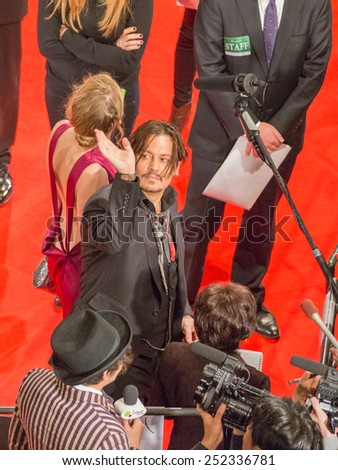 Tokyo - January 27, 2015: Johnny Depp and Amber Heard in a thin beautiful fuchsia dress at the launch of the film \