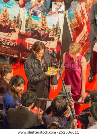 Tokyo - January 27, 2015: Johnny Depp gives interviews and Amber Heard in a thin fuchsia dress at the launch of the film \