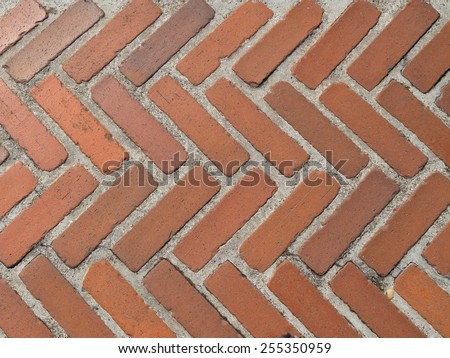 old garden path of red coarse chipped bricks with thick seams