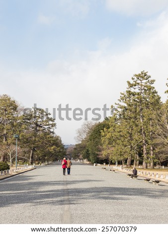 Tokyo - February 4, 2015: Park in the city center, a young couple walking along a dirt road, and the old man looks at young people February 4, 2015, Tokyo, Japan