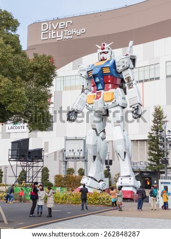 Tokyo - February 7, 2015: People walk and take pictures with a huge space robot at a shopping center in the city pedestrian area of ÃÂ¢??ÃÂ¢??Odaiba in early spring February 7, 2015, Tokyo, Japan